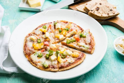 127311495-chapati-pizza-made-using-leftover-roti-paratha-with-cheese-vegetables-paneer-and-sausage-kbaez4v0